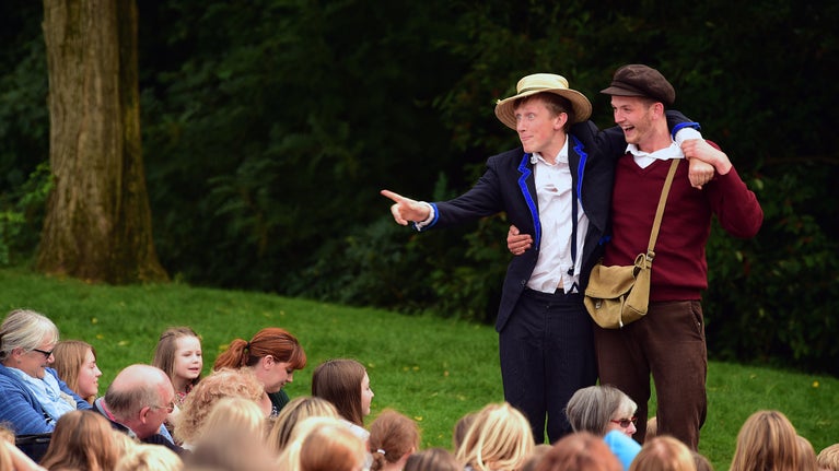 Performers and visitors at an outdoor theatre show at Cliveden, Buckinghamshire